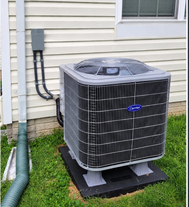New outdoor air conditioning unit installed on a level pad beside a home
